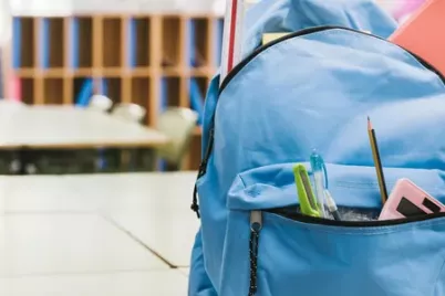 blue-schoolchild-backpack-on-table.webp