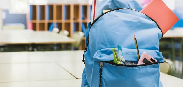 blue-schoolchild-backpack-on-table.webp